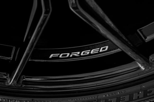 Close-up of a black forged alloy wheel with sleek design elements.custom forged wheels – forged vs cast wheels comparison